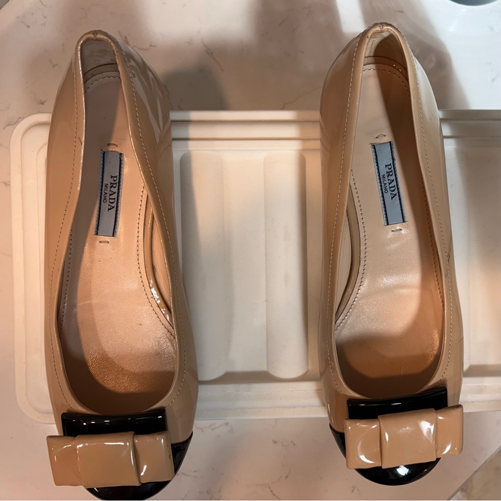 Prada Women's Nude Patent Leather Flats with Black Bow